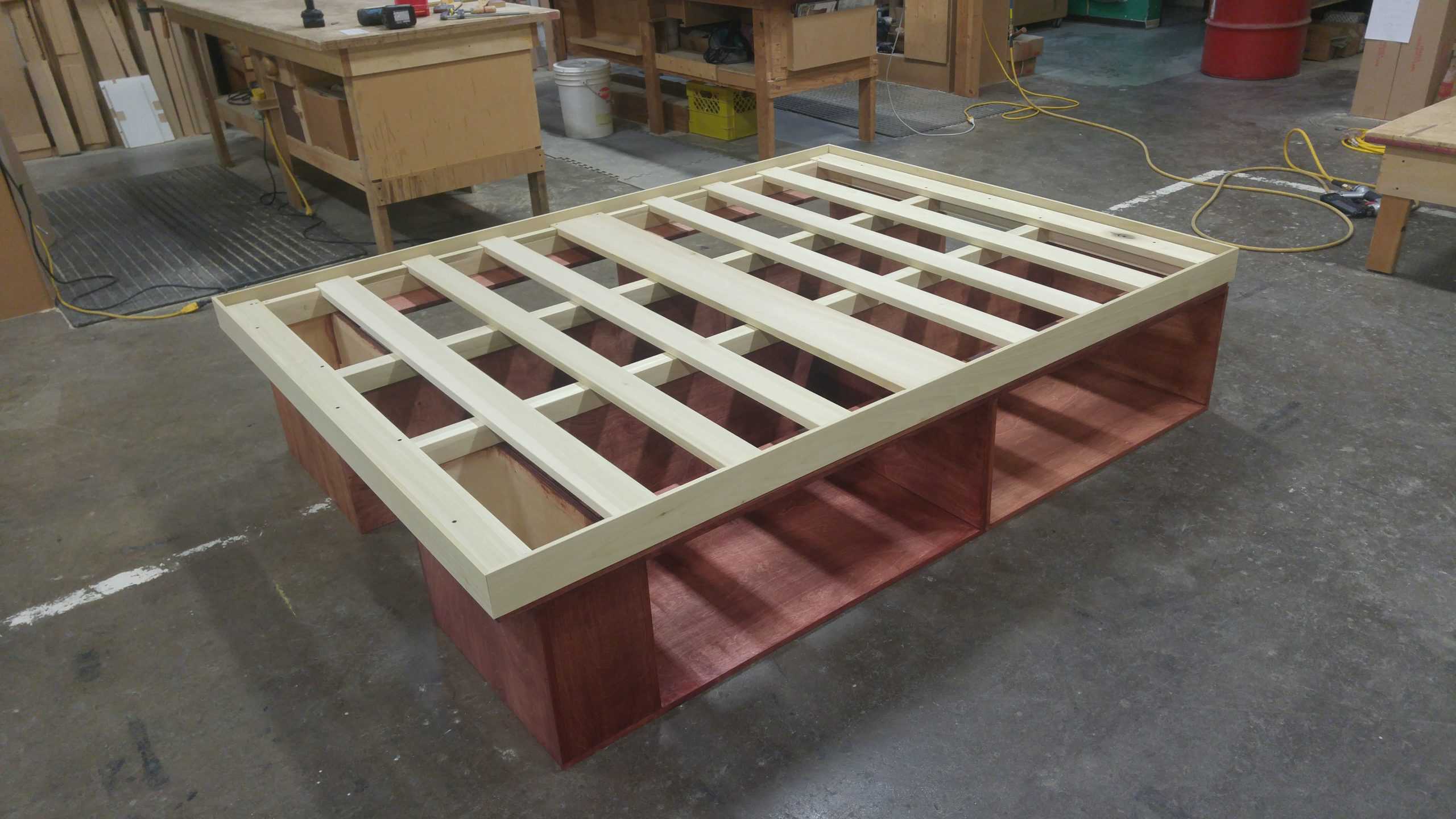 bed frame with slats under construction in woodworking shop